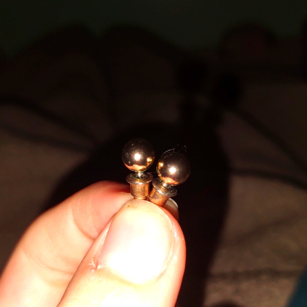 Two gold stud earrings